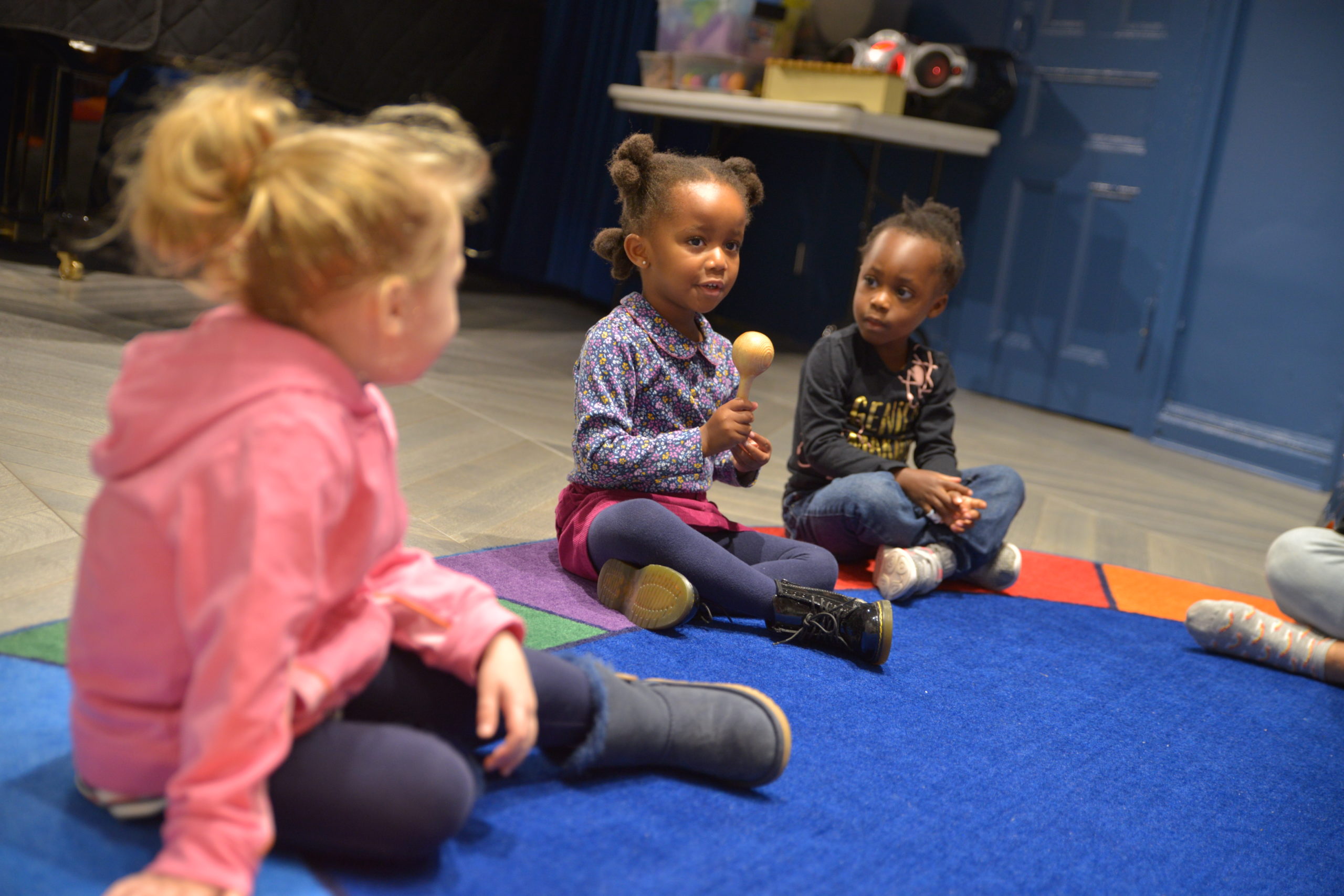 Young children exploring maracas during an early childhood music class in NYC